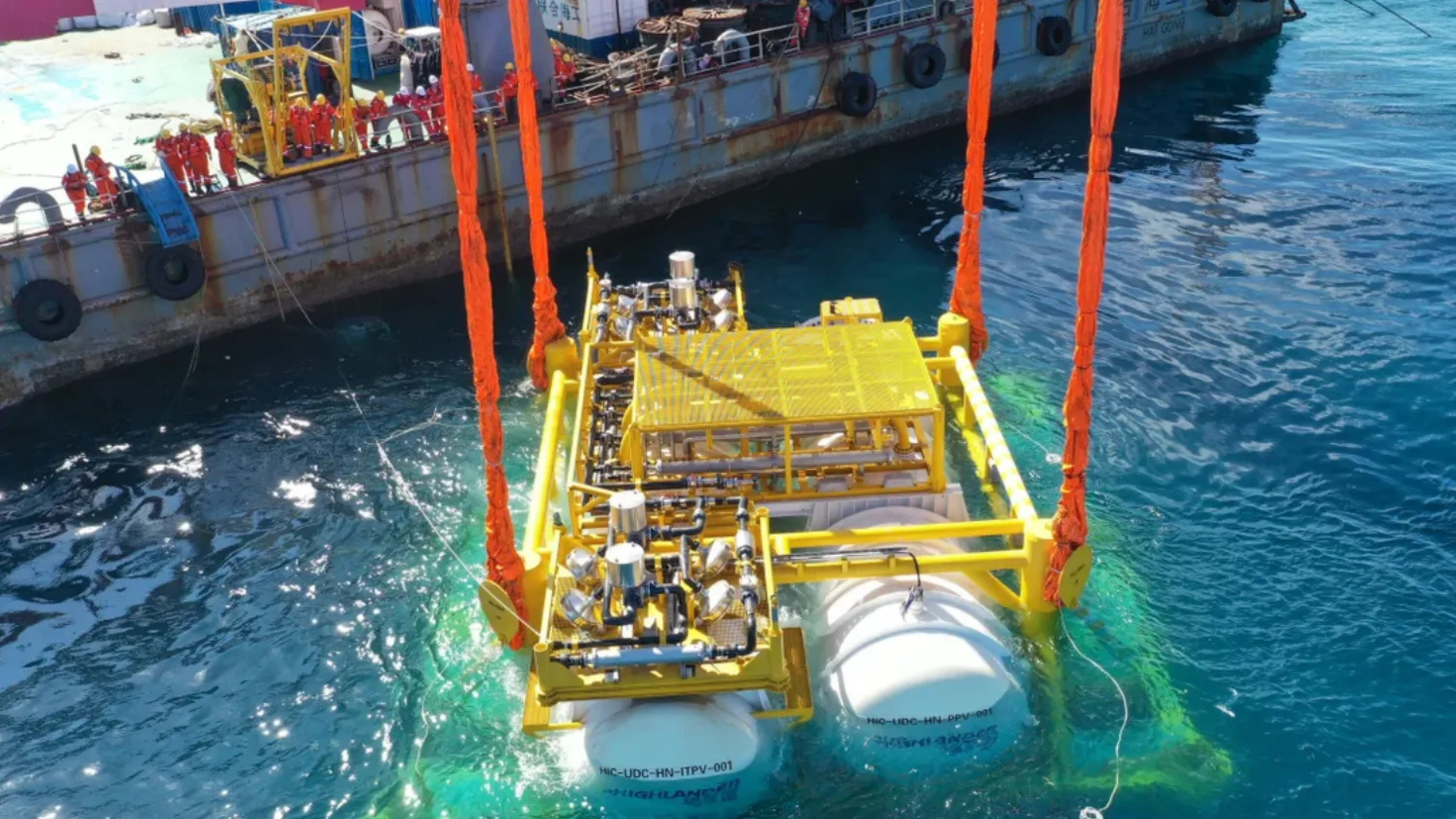 An artist's rendition of an underwater data center module submerged beneath the ocean surface, with offshore wind turbines visible above.