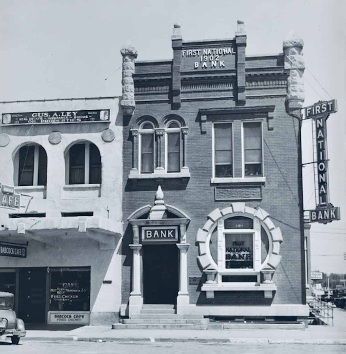 Outdated bank mainframe servers contrasted with sleek fintech payment apps on mobile