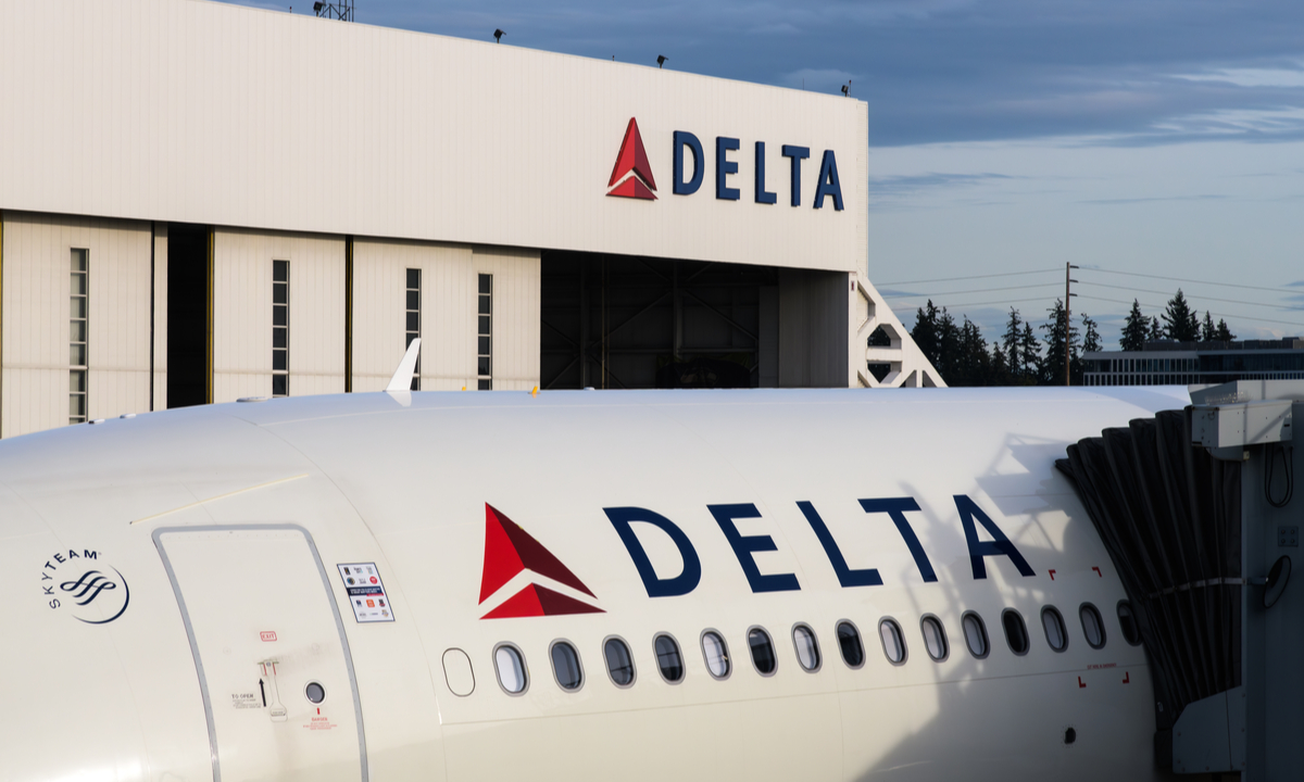 Delta Air Lines airplane on tarmac with rising fuel price graph overlay