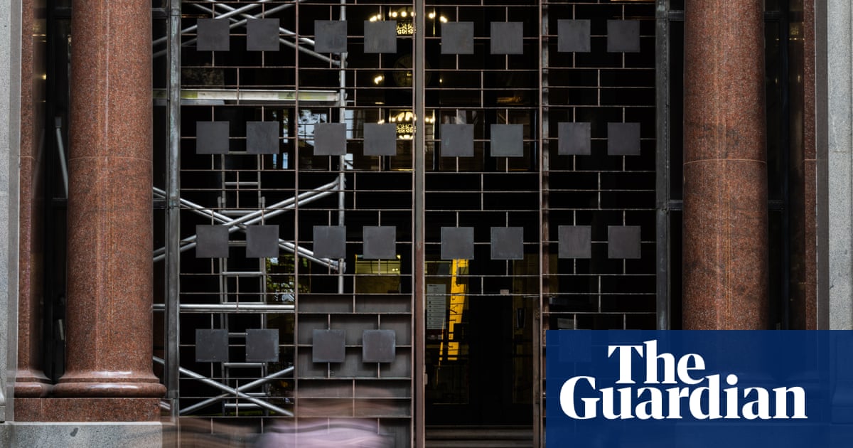 Shocked Atlassian employee staring at layoff email on laptop screen