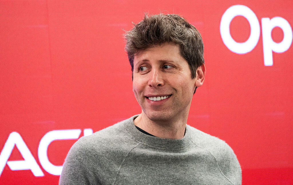 Sam Altman at podium with OpenAI logo amid skeptical audience