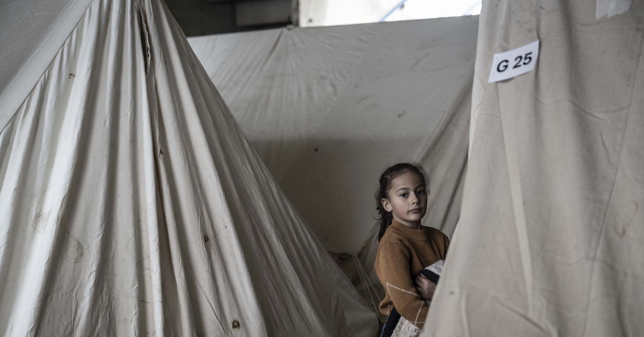 Smartphone displaying digital wallet transfer amid Lebanese displacement camps