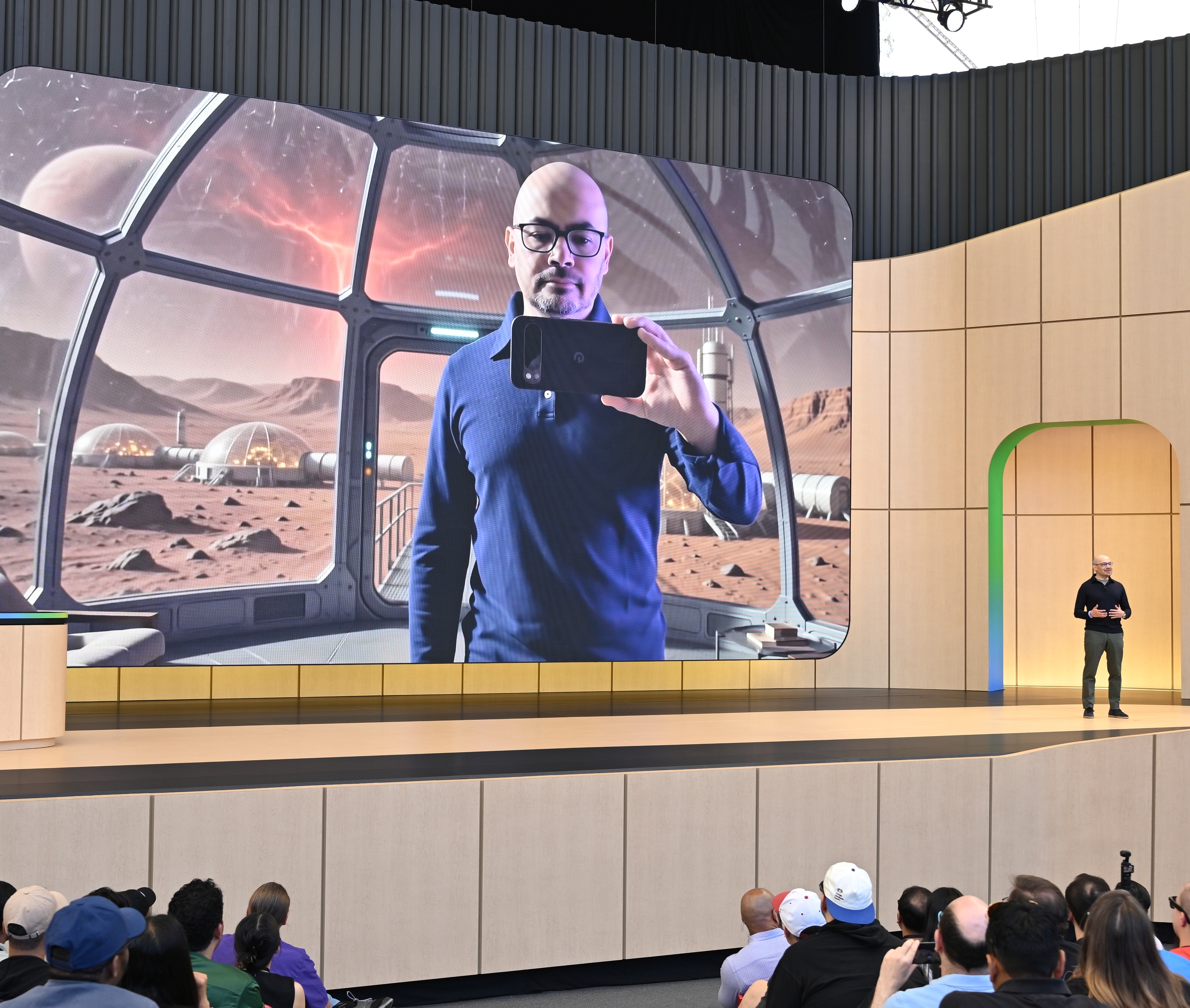Demis Hassabis on stage at Google I/O discussing AI.