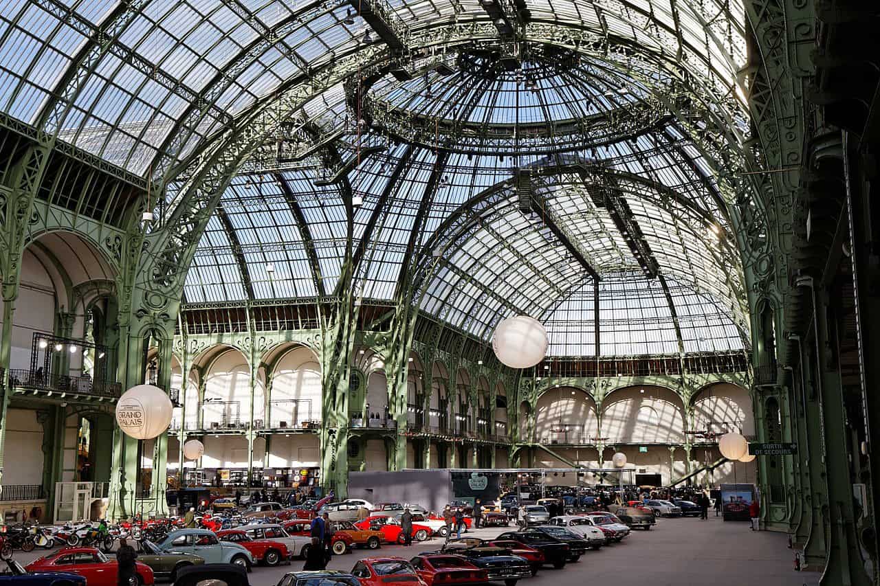 Paris Grand Palais hosting 2025 AI Action Summit with AI safety leaders and glowing digital overlays