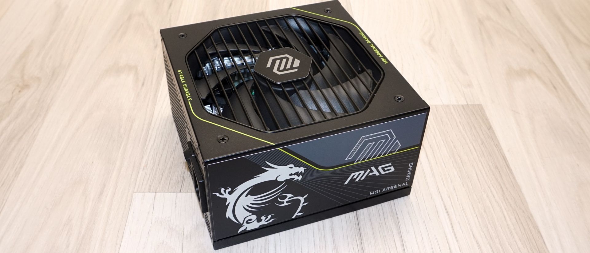 MSI MAG A1200PLS PCIE5 1200W power supply with yellow accents and modular cables