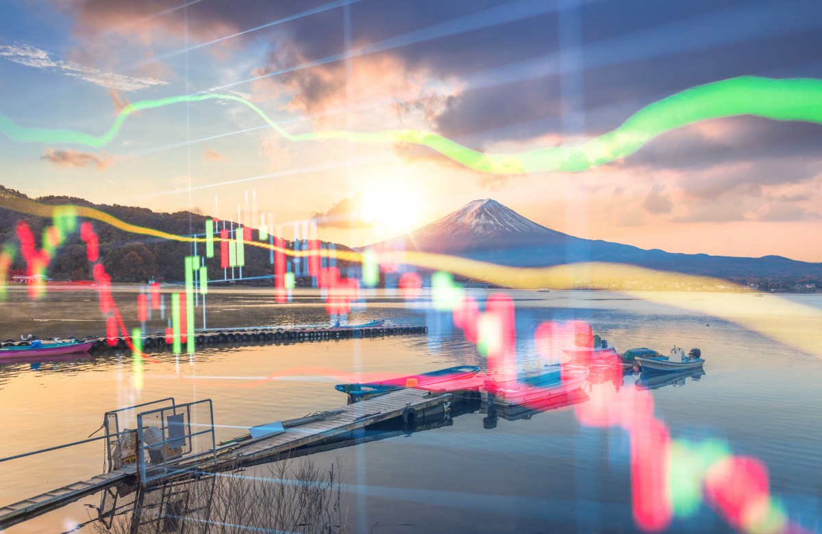 Industrial robot arm precisely assembling electronics in a bustling Japanese factory