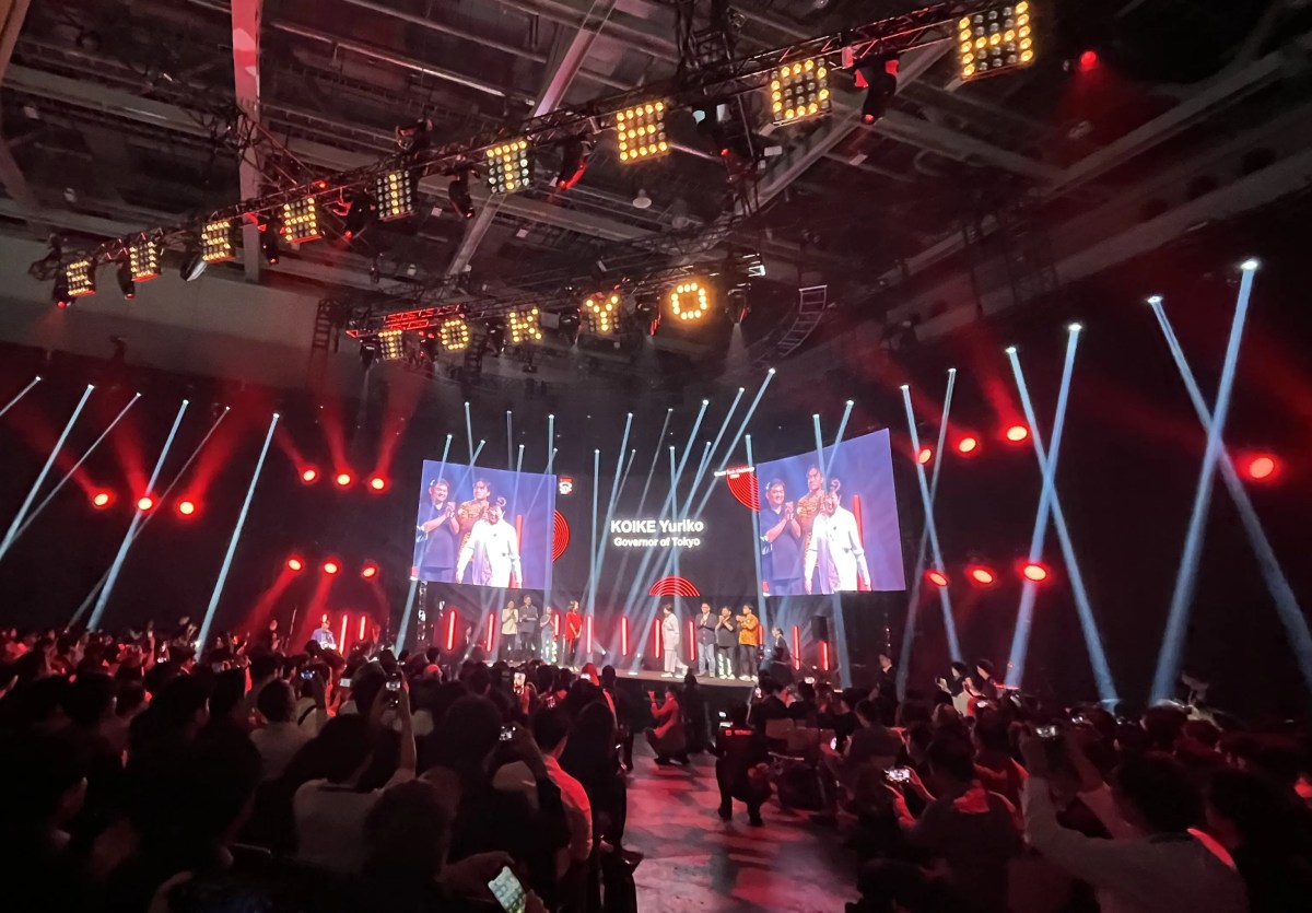 A vibrant cityscape of Tokyo at night, with futuristic holographic displays showcasing AI and robotic imagery.