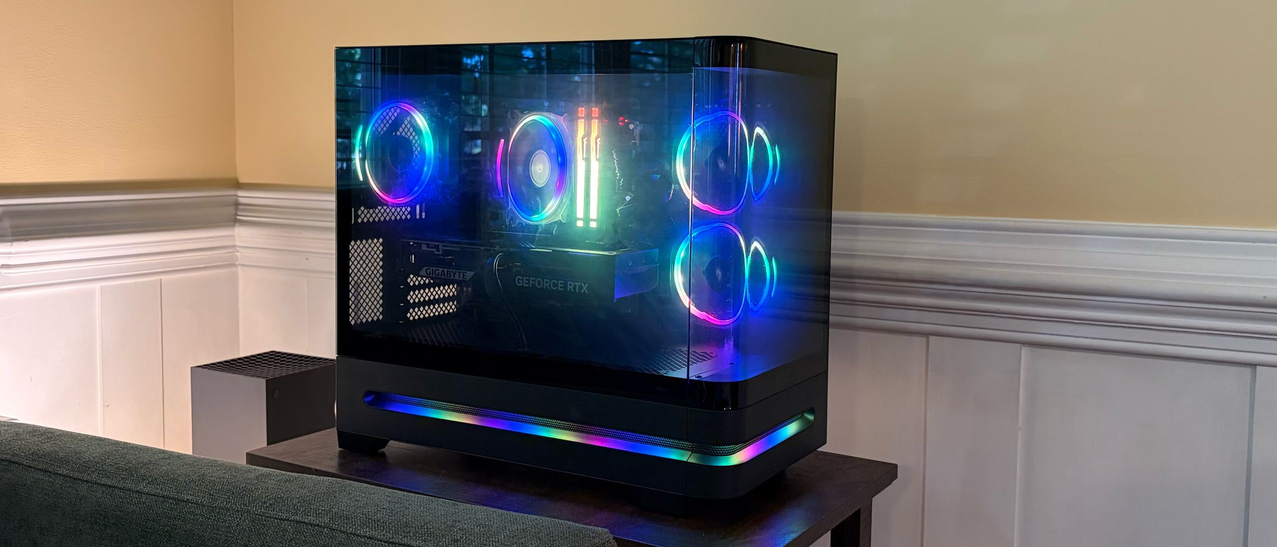 Side profile of the Acer Nitro 65 gaming PC showcasing its curved glass front and RGB lighting.