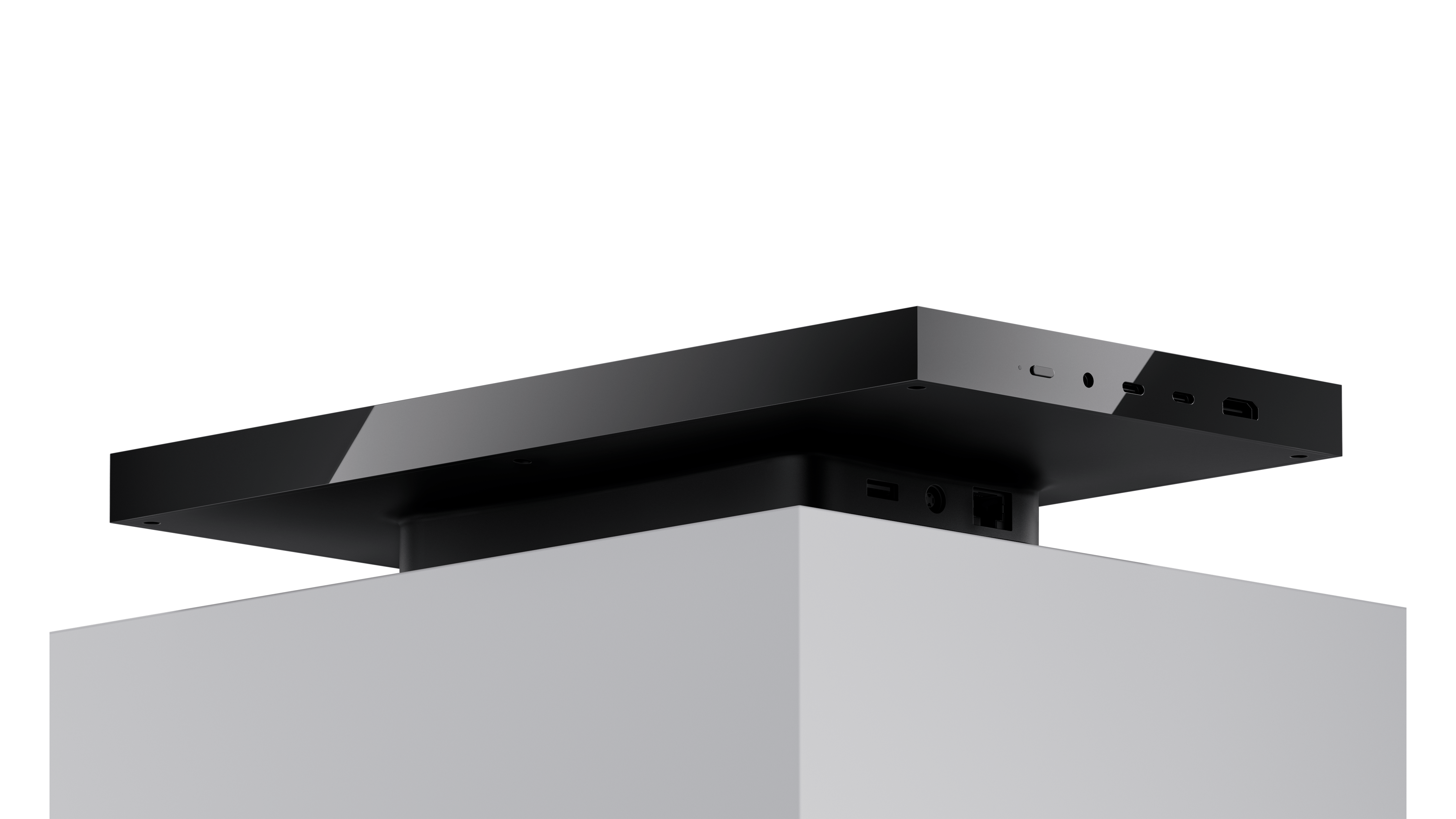 A compact, dark grey aluminum box resembling a small server or mini PC, with subtle branding.