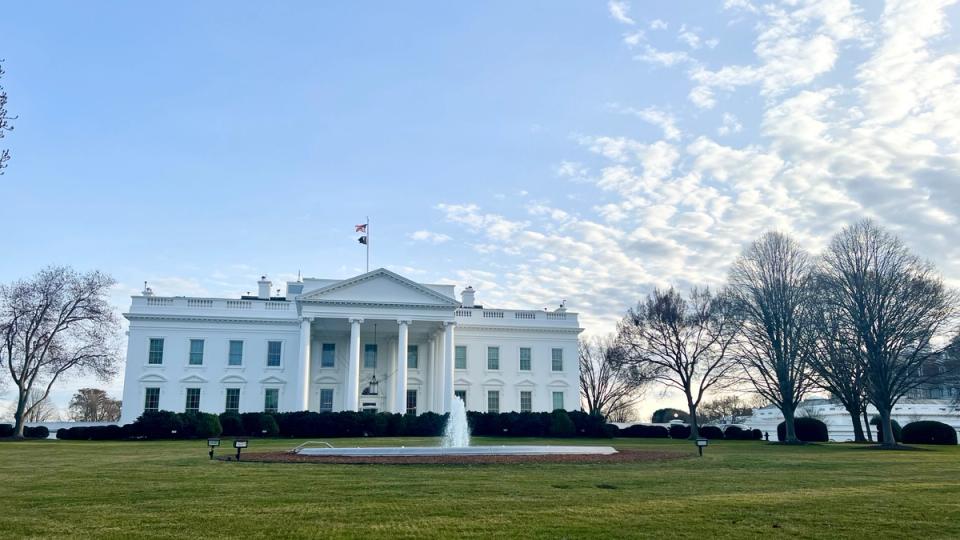 White House podium with crypto stablecoin icons and bank vault in background