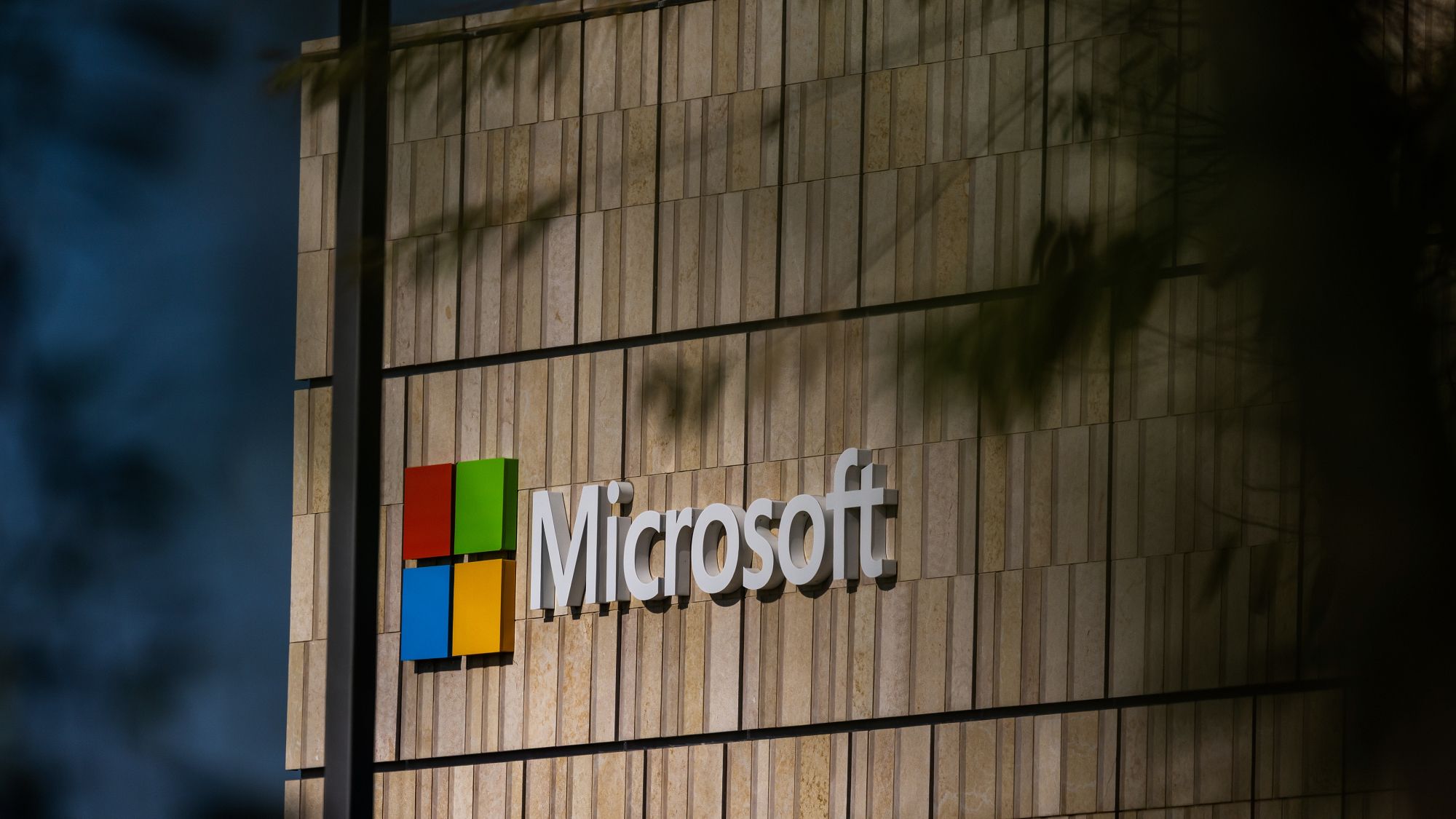 Collage of Nvidia, Apple, Microsoft logos overlaid with IRGC threat Telegram screenshot and Middle East map