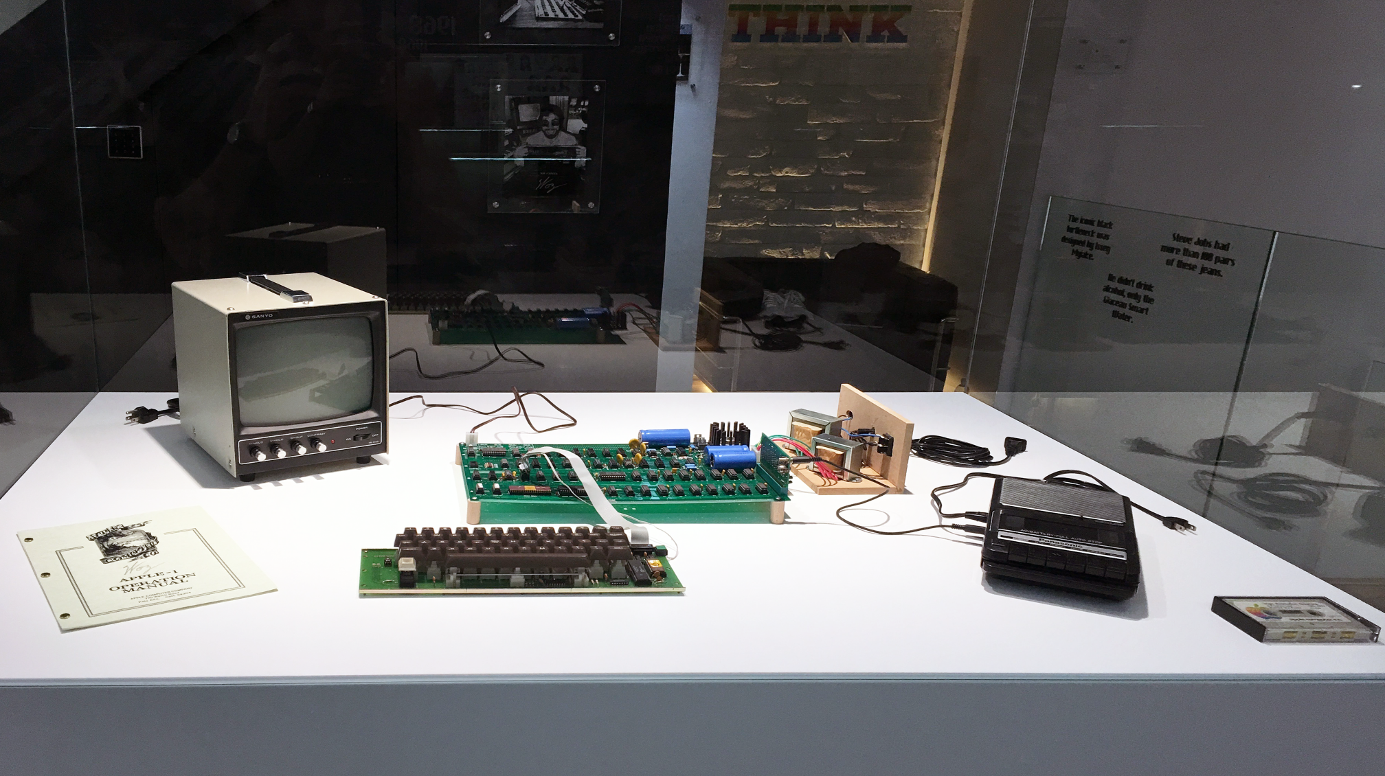 Vintage Apple-1 circuit board juxtaposed with sleek modern MacBook Air