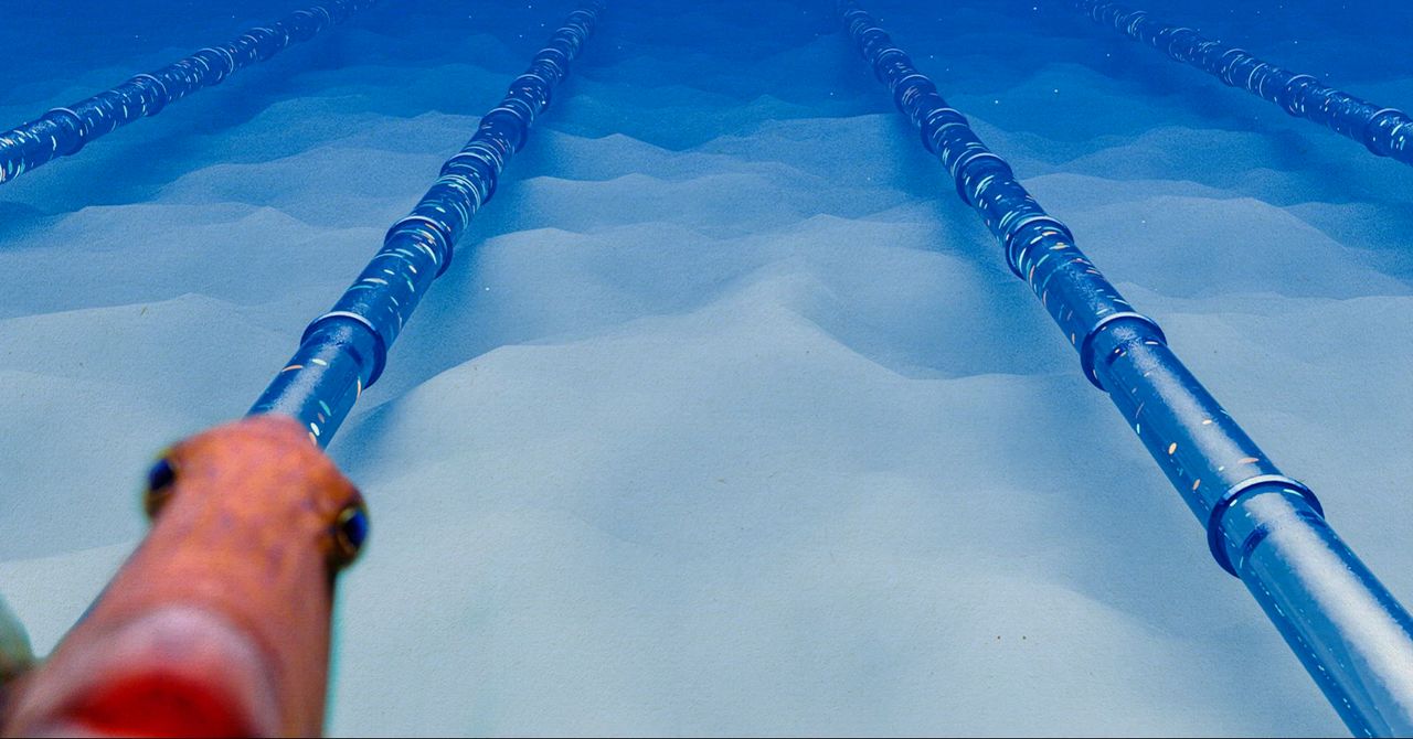 A diagram showing undersea fiber optic cables running across the ocean floor, with a small graphic of a data center on land.
