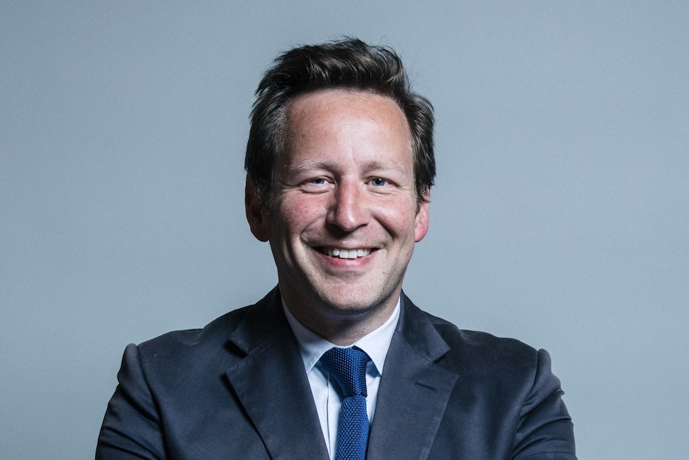 Overlapping UK government logos with confused AI startup founder silhouette