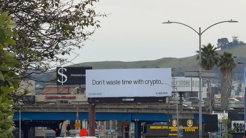 San Francisco billboard by Solana Foundation reading 'Don’t waste time with crypto' with arrow to x402
