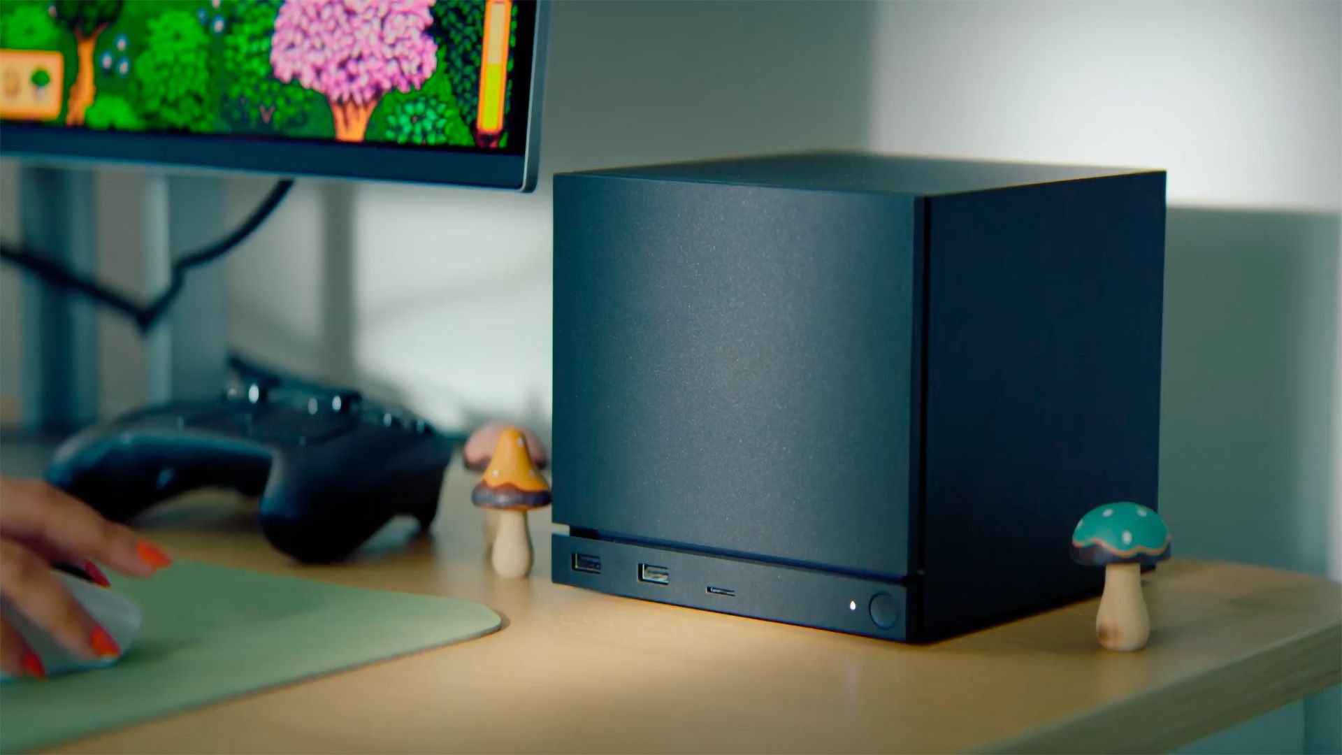 A dimly lit, slightly out-of-focus image of a gaming console with a subtle blue glow.