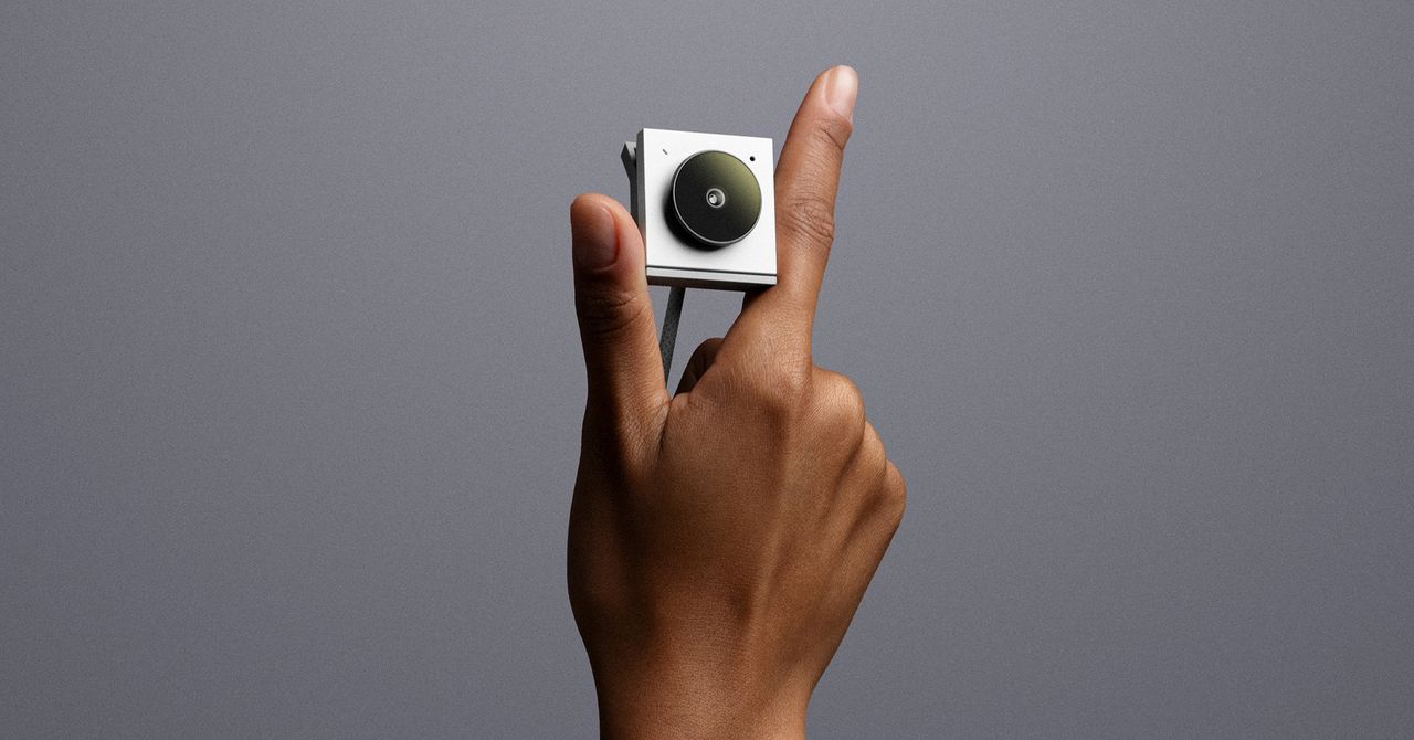 A conceptual image of a sleek, minimalist audio device on a table.