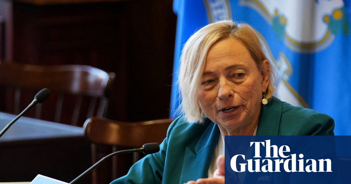 A modern, sleek datacenter building at dusk, with subtle lighting.