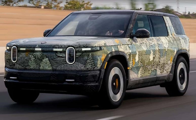 Rivian R2 SUV on highway with AI autonomy visualization overlay
